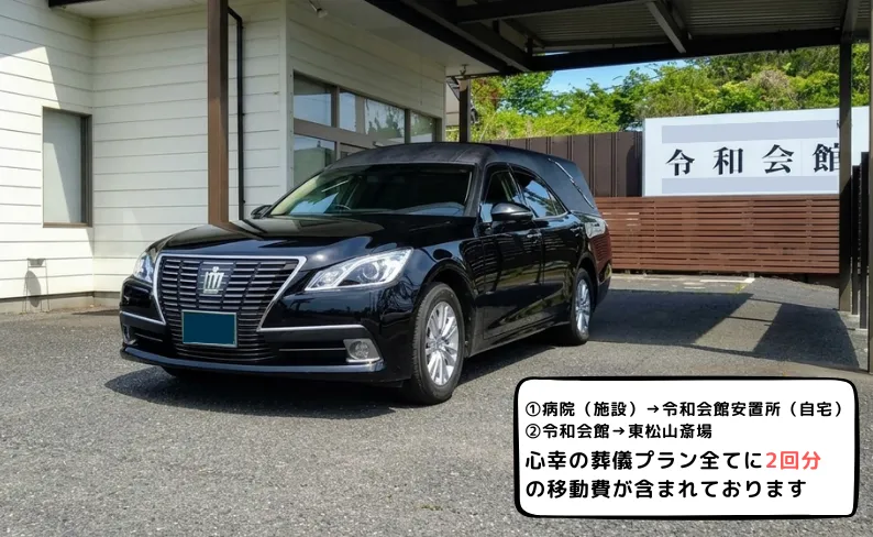 令和会館の前の霊柩車の写真
テキスト：病院（施設）→令和会館安置所
令和会館→東松山斎場
心幸の全ての葬儀プランに2回分の移動費が含まれております
